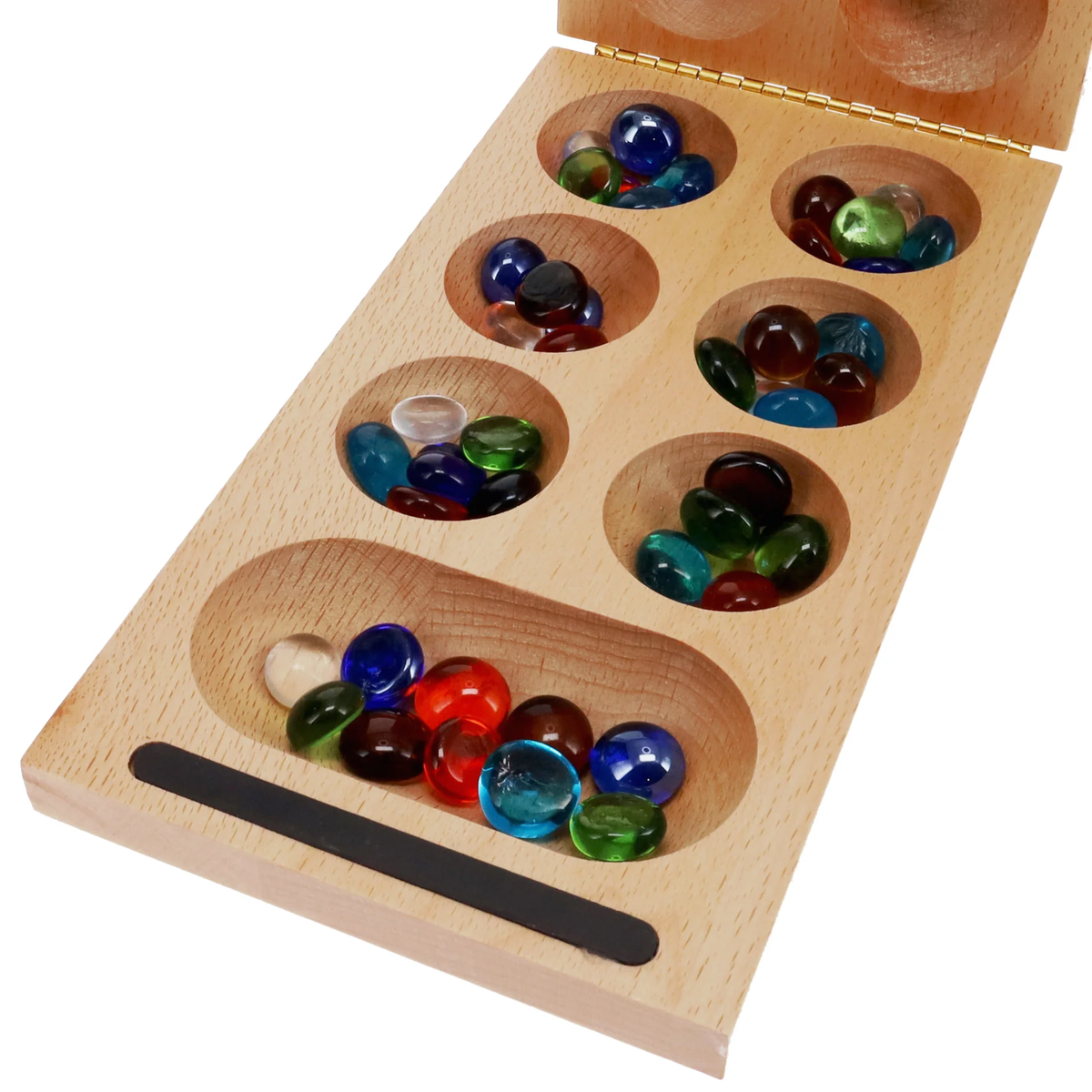 Close-up of folding wooden Mancala board with colorful glass stones and carved playing wells