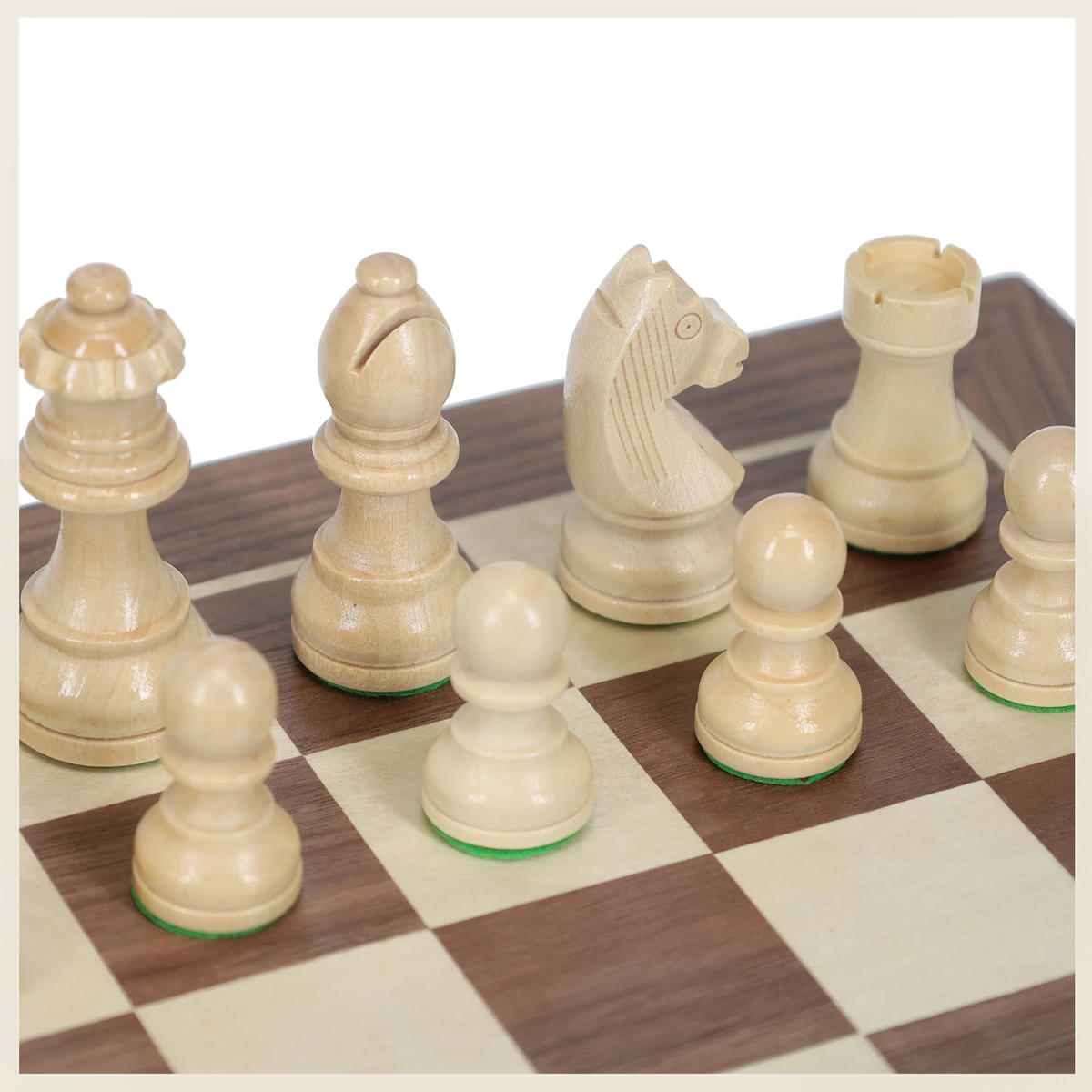 Close-up of natural wood chess pieces showing carved knight, wood grain, and felt bottoms