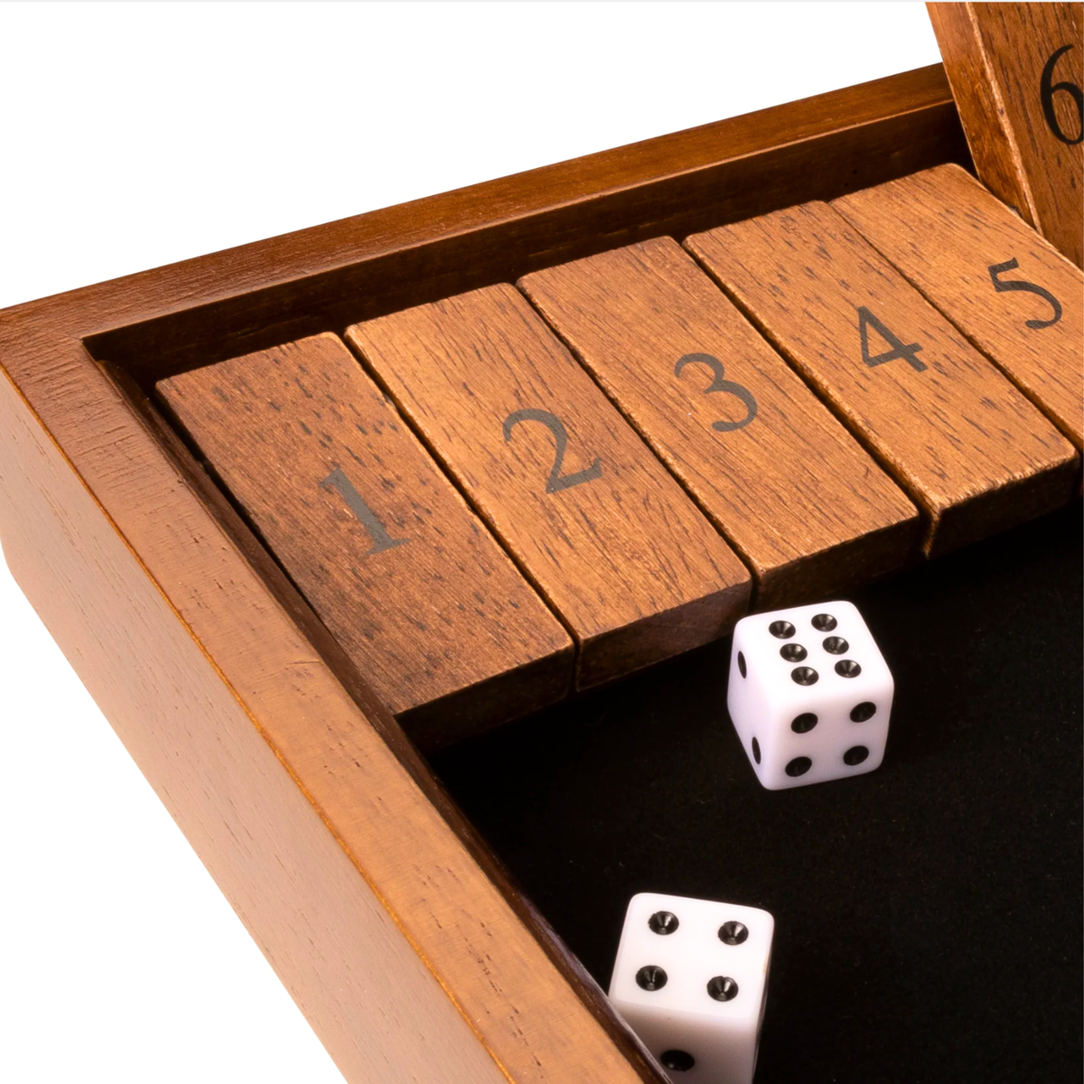 Close-up of wooden Shut the Box game with numbered flip tiles, dice, and black felt playing surface