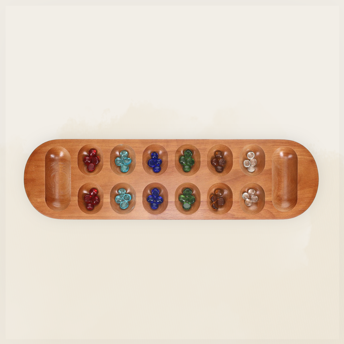Full wooden Mancala board with colorful glass stones arranged in the playing wells